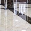 Marble floor in the luxury lobby of office or hotel. Real floor tile pattern with reflections for background. Shiny floor after professional cleaning.