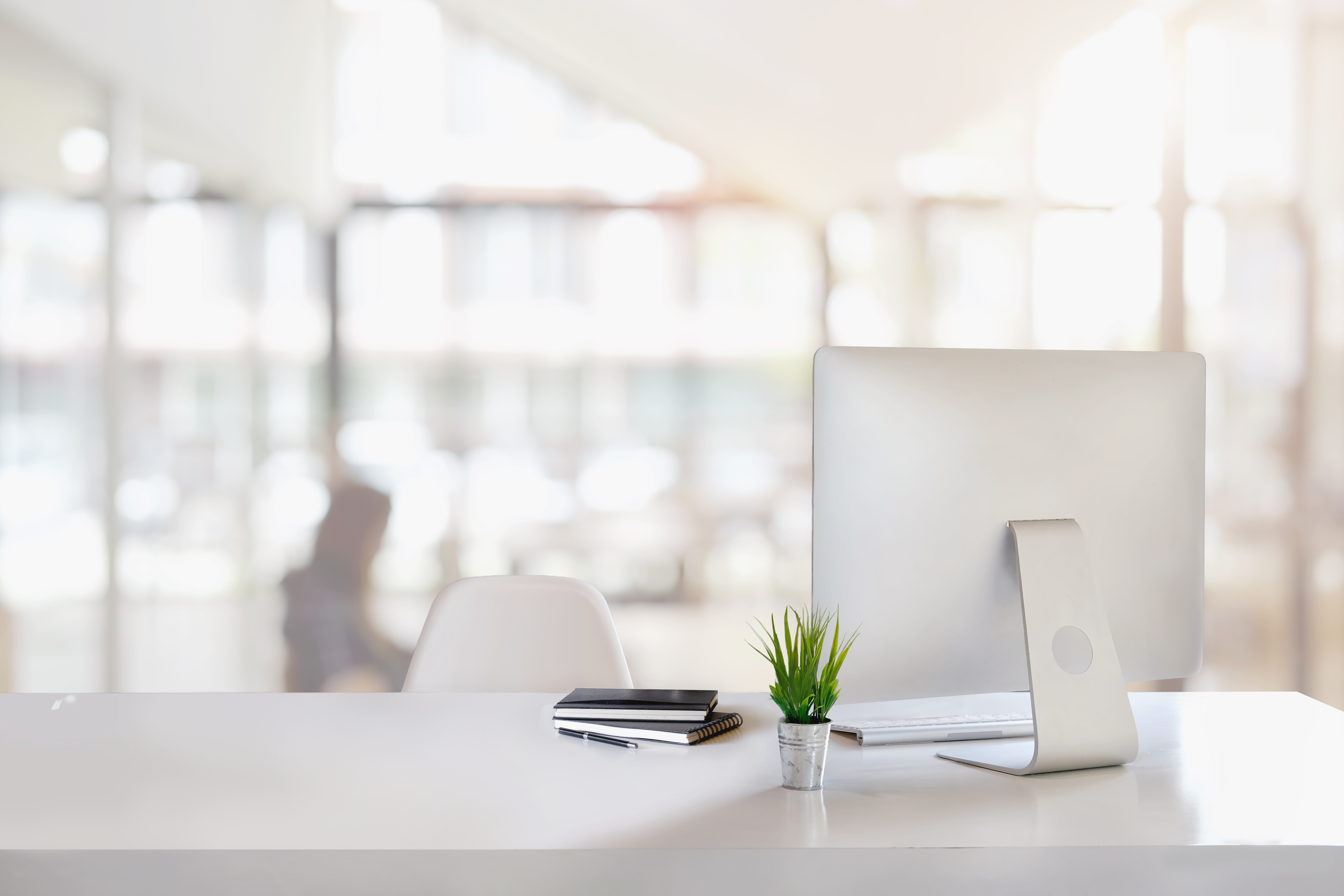 Stylish workspace with desktop computer, office supplies, houseplant and books at office. desk work concept. A clean workplace - Cleaning Solution
